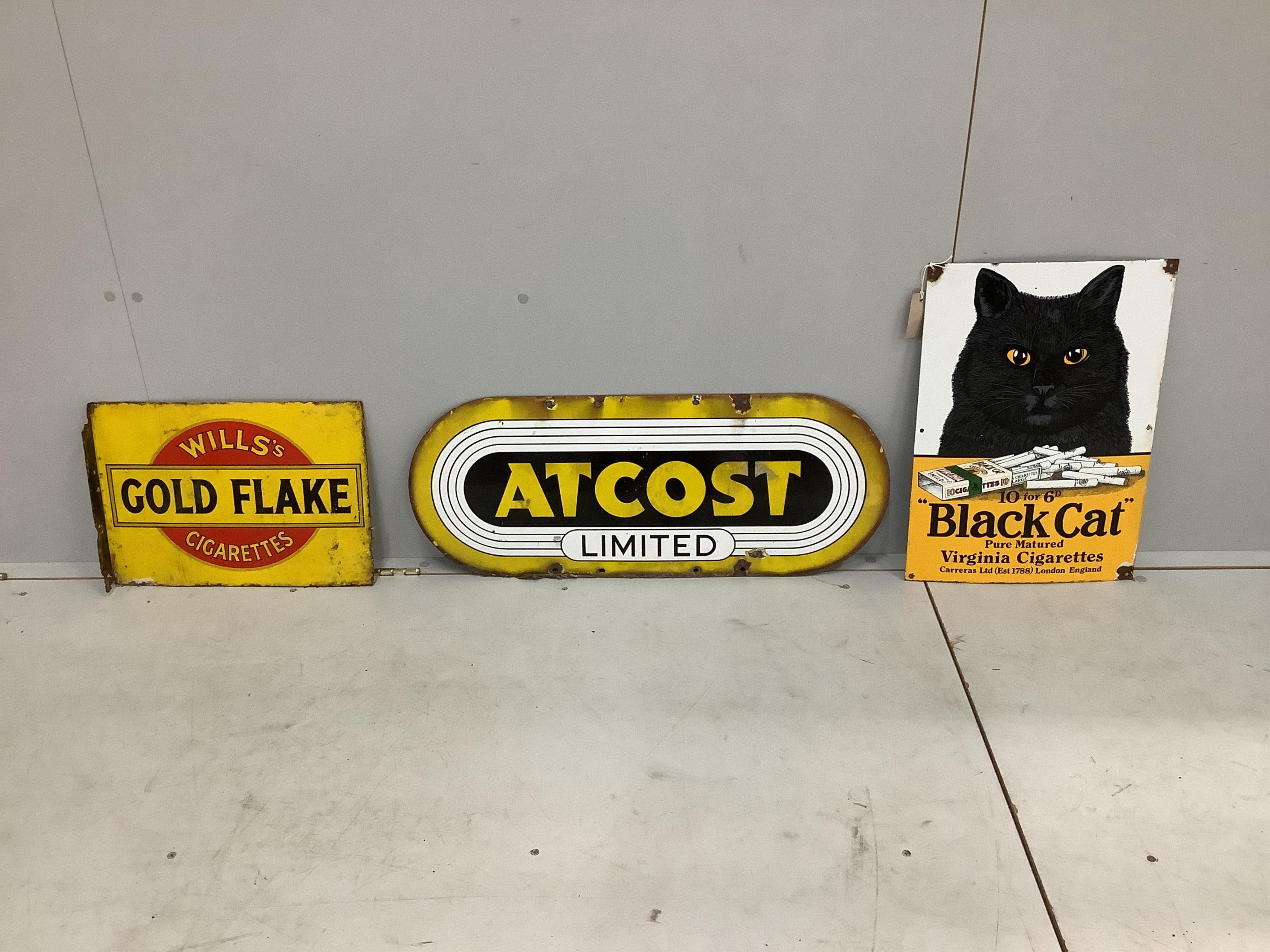A vintage 'Wills's Gold Flake' two sided enamelled advertising sign, an 'Atcost' sign and a reproduction 'Black Cat Cigarettes' sign, width 35cm